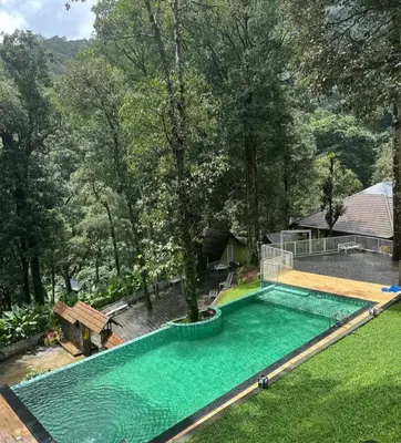 an overhead view of a swimming pool in a yard at Zeno Village Resort 900 Kandi Wayanad in Wayanad