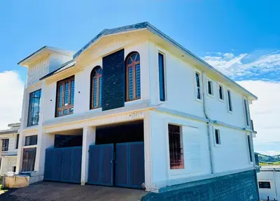 a white house with a blue fence at Ever Fresh High View By Let's Inn in Ooty