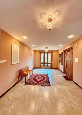a living room with a couch and a rug at Ever Fresh High View By Let's Inn in Ooty