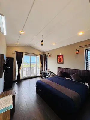 a bedroom with a large bed and a large window at Ever Fresh High View By Let's Inn in Ooty