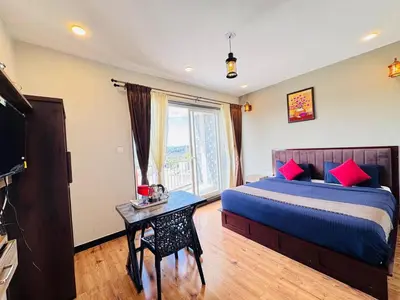 a bedroom with a bed and a table with a television at Ever Fresh High View By Let's Inn in Ooty