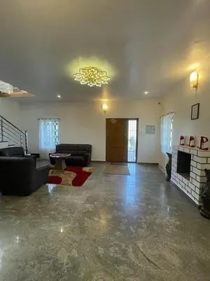 a living room with a couch and a fireplace at IndivaStays - Moon Stone Villa in Ooty