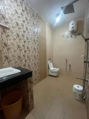 a bathroom with a toilet and a sink and a shower at IndivaStays - Moon Stone Villa in Ooty