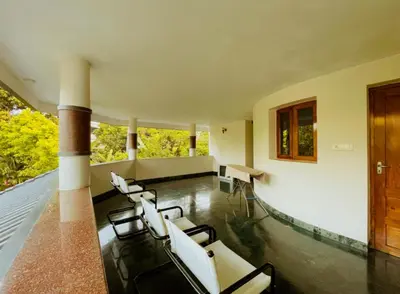 a room with a group of chairs and a fireplace at Upavan Villa-Two KM From Aluva Metro Station in Alwaye