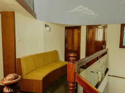 a living room with a couch and a staircase at Upavan Villa-Two KM From Aluva Metro Station in Alwaye