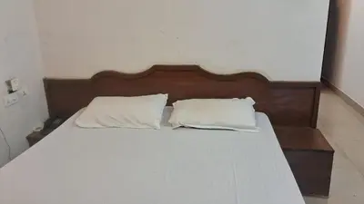 a bed with two white pillows on top of it at Hill palace Inn in Periya