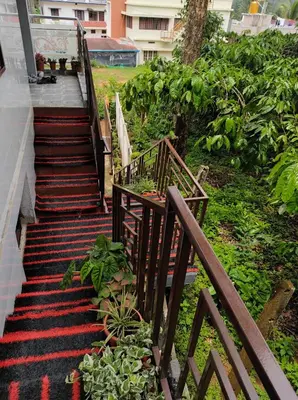 a set of stairs leading up to a house at Maurya Homestay in Napoklu