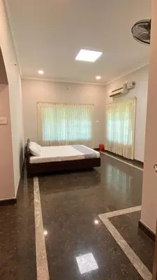 a bedroom with a large bed in a room at Abida Mansion 4BHK Near MCP Convention Centre Irinjalakuda in Irinjālakuda