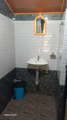 a bathroom with a sink and a mirror at Mud bees resort in Kanthalloor