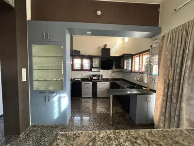 a kitchen with a sink and a counter top at Aalaya in Mysore