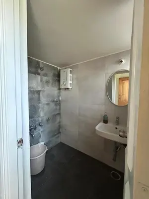 a bathroom with a sink and a mirror at Aalaya in Mysore