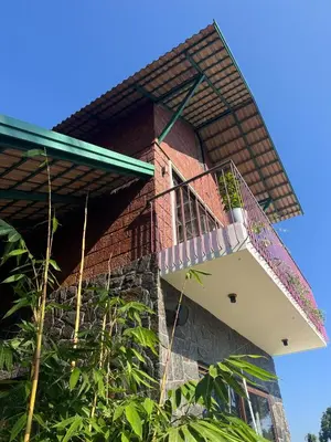 a building with a staircase on the side of it at Hill Brown Resort in Kalpetta
