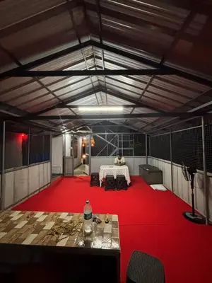 a large room with a red carpet and a table at ViAN Mistyrocks in Mamalakandam