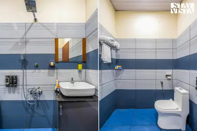 a blue and white bathroom with a toilet and a sink at StayVista at Aradhya Villa with Infinity Pool, Lawn in Wayanad