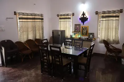 a dining room with a table and chairs at Anava Farms in Shrīrangapattana