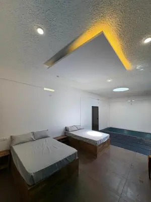 a room with two beds and a ceiling at DEEP ViLLA in Batheri