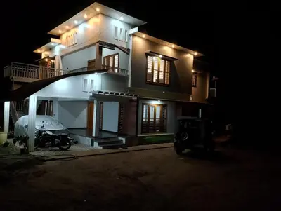 a house at night with a car parked in front of it at Anishanchala in Madikeri