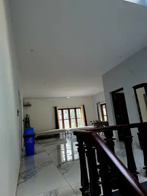 an empty room with a staircase in a house at Anishanchala in Madikeri