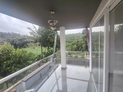 a balcony of a house with a view at Savisos home in Padinjarathara
