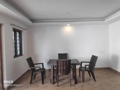 a dining room with a table and chairs at Lush Green View Cottage 3BH in Ooty