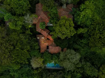 an aerial view of a house in the middle of a forest at Avana Holiday Experiences,Wayanad in Kalpetta