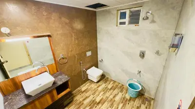 a bathroom with a sink and a toilet and a mirror at Teyt Grand View in Ketti