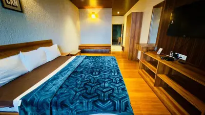 a bedroom with a large bed with a blue blanket at Teyt Grand View in Ketti