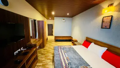 a bedroom with a bed and a flat screen tv at Teyt Grand View in Ketti