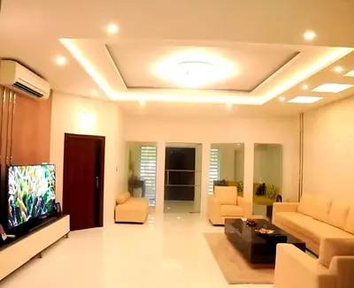 a living room with couches and a flat screen tv at Karthika Residency Parakkadavu in Nedumbassery