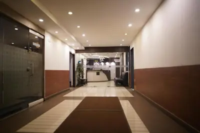 an office hallway with a lobby with a chair at Wynad Hotel in Kozhikode