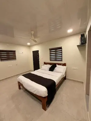 a bedroom with a large bed in a room at Tusker & Gaur - Bandipur