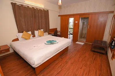 a bedroom with a bed with a cake on it at Hotel Vivek in Coonoor