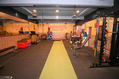 a gym with a yellow stripe on the floor at Hotel Vivek in Coonoor