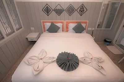 a bedroom with a bed with bows on it at Hotel Vivek in Coonoor
