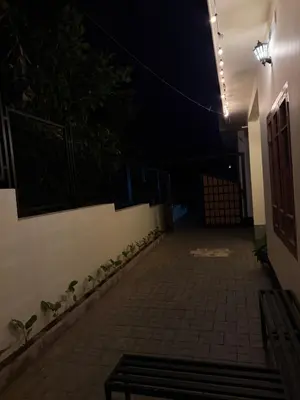 a dark alley with a bench in a building at night at Ethnic Family Spot Wayanad in Kenichira