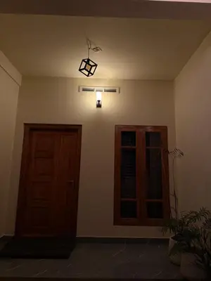 an empty room with a door and a light at Ethnic Family Spot Wayanad in Kenichira
