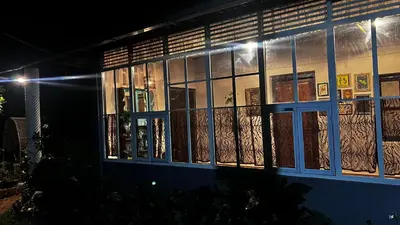 a building with windows lit up at night at Massbungalow in Tindummal