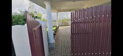 a wooden gate to a house with a walkway at Sathya Holidays Evermist Stay in Ooty