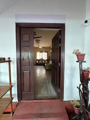 an open door into a room with a living room at Rose villa in Coimbatore
