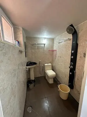 a small bathroom with a toilet and a sink at Rose villa in Coimbatore