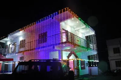 a house is decorated with christmas lights at Carmel Cottage in Marayoor