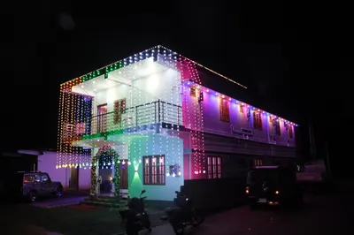 a house is lit up with christmas lights at Carmel Cottage in Marayoor