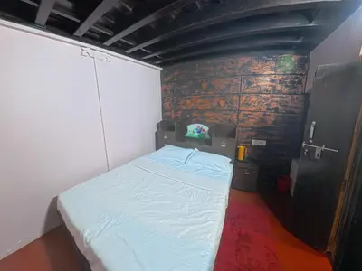 a small bedroom with a white bed in it at Bucolic Resort in Panamaram