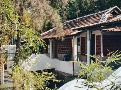 a cottage in the middle of a garden at Bamboo villa in Cochin
