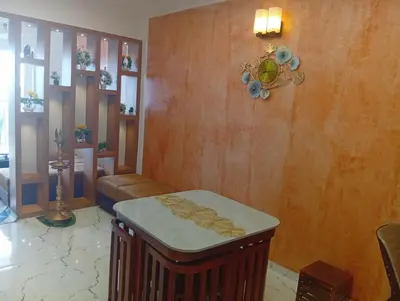 a living room with a couch and a table at Gurunandanam-Fully furnished Deluxe Apartment East Nada Guruvayur in Guruvāyūr