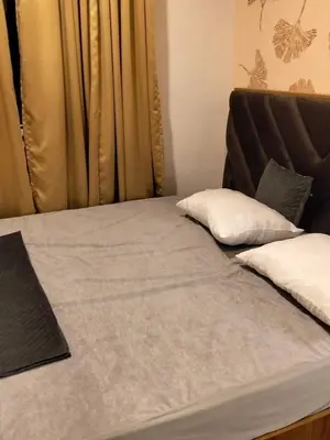 a bed with two pillows on top of it at Gurunandanam-Fully furnished Deluxe Apartment East Nada Guruvayur in Guruvāyūr