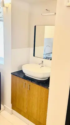 a bathroom with a sink and a mirror at BOHO Living Kochi Airport in Ernakulam