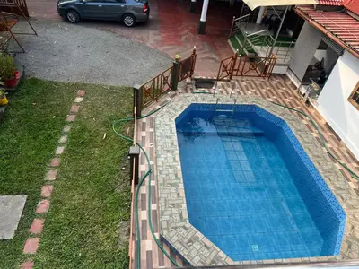 an overhead view of a swimming pool in a yard at The Trio in Kalpetta