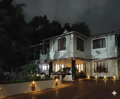 a house at night with lights in front at Lead Homestay Chalakudy in Kizhake Chālakudi