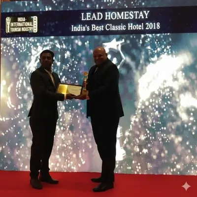 two men are holding up an award on a red carpet at Lead Homestay Chalakudy in Kizhake Chālakudi